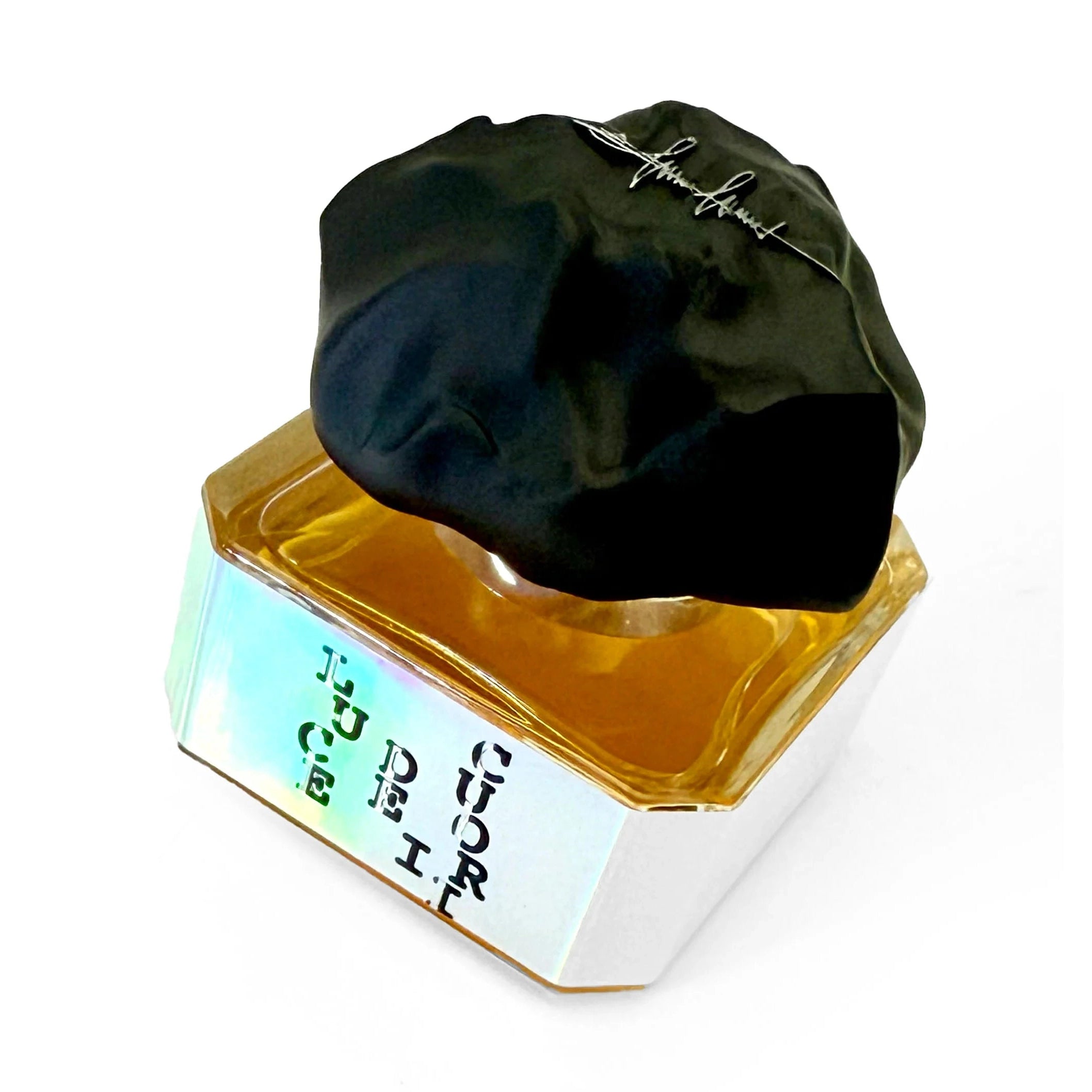 Close-up of Filippo Sorcinelli Luce Dei Cuori faceted glass bottle with matte black cap and shifting label