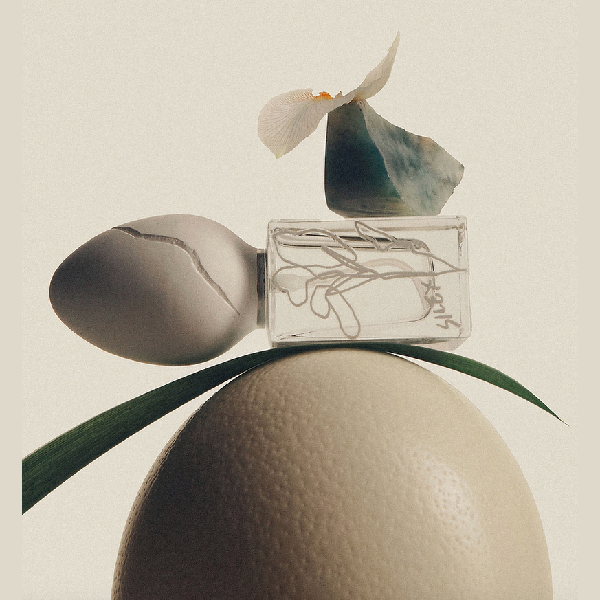 Silex mineral perfume bottle lying on citrus sphere with dried flower detail