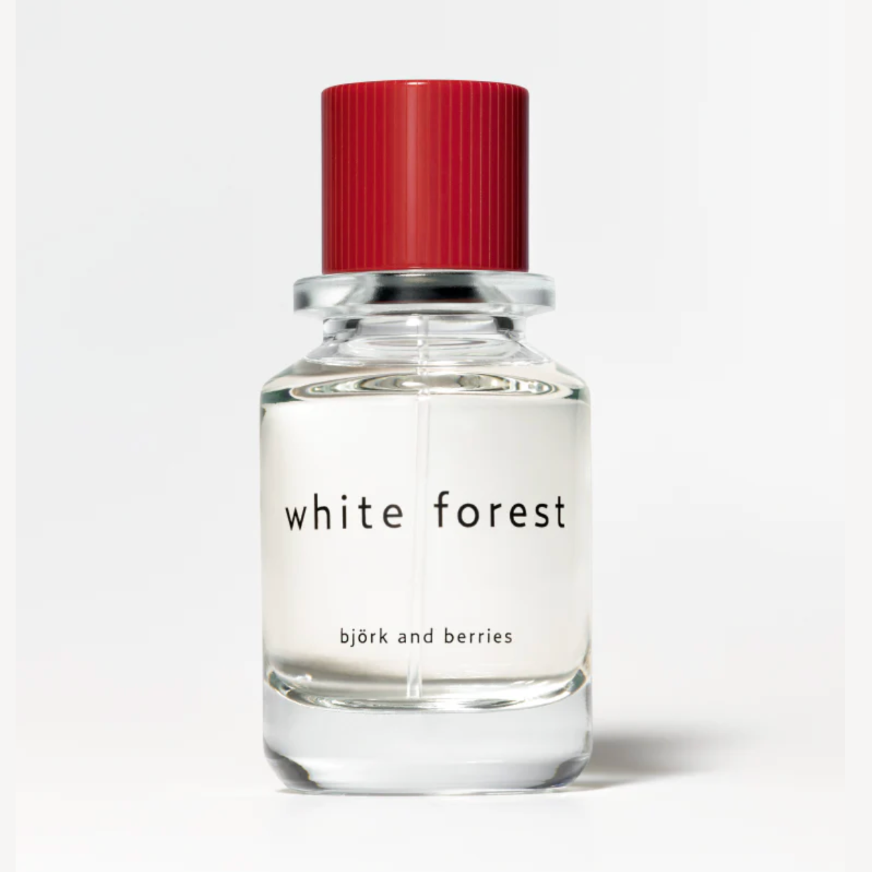 Bjork and Berries White Forest Eau de Parfum in clear glass bottle with red ribbed cap