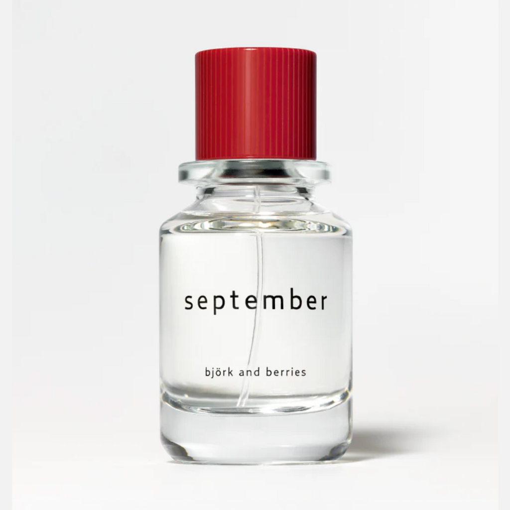 Bjork and Berries September Eau de Parfum in clear glass bottle with red ribbed cap
