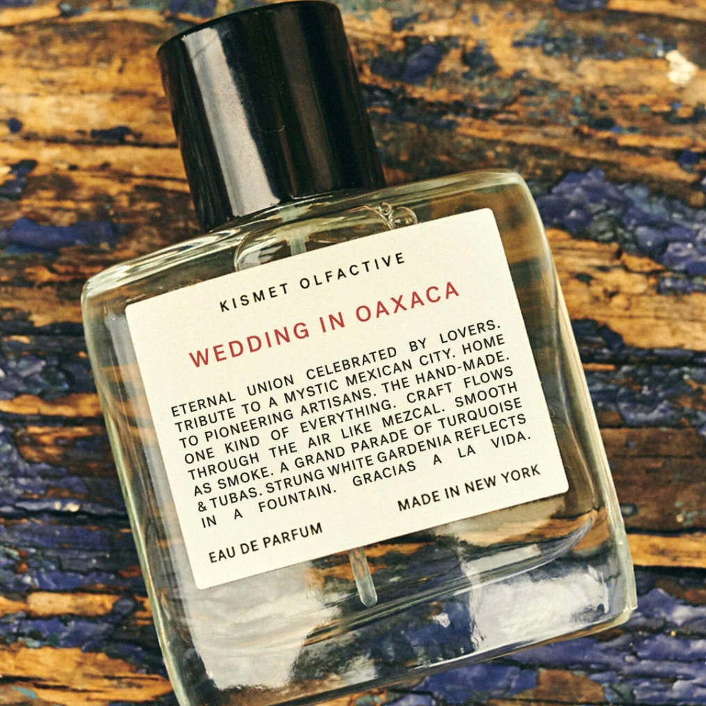 Kismet Olfactive Wedding in Oaxaca fragrance bottle with vetiver and sandalwood on rustic wooden surface