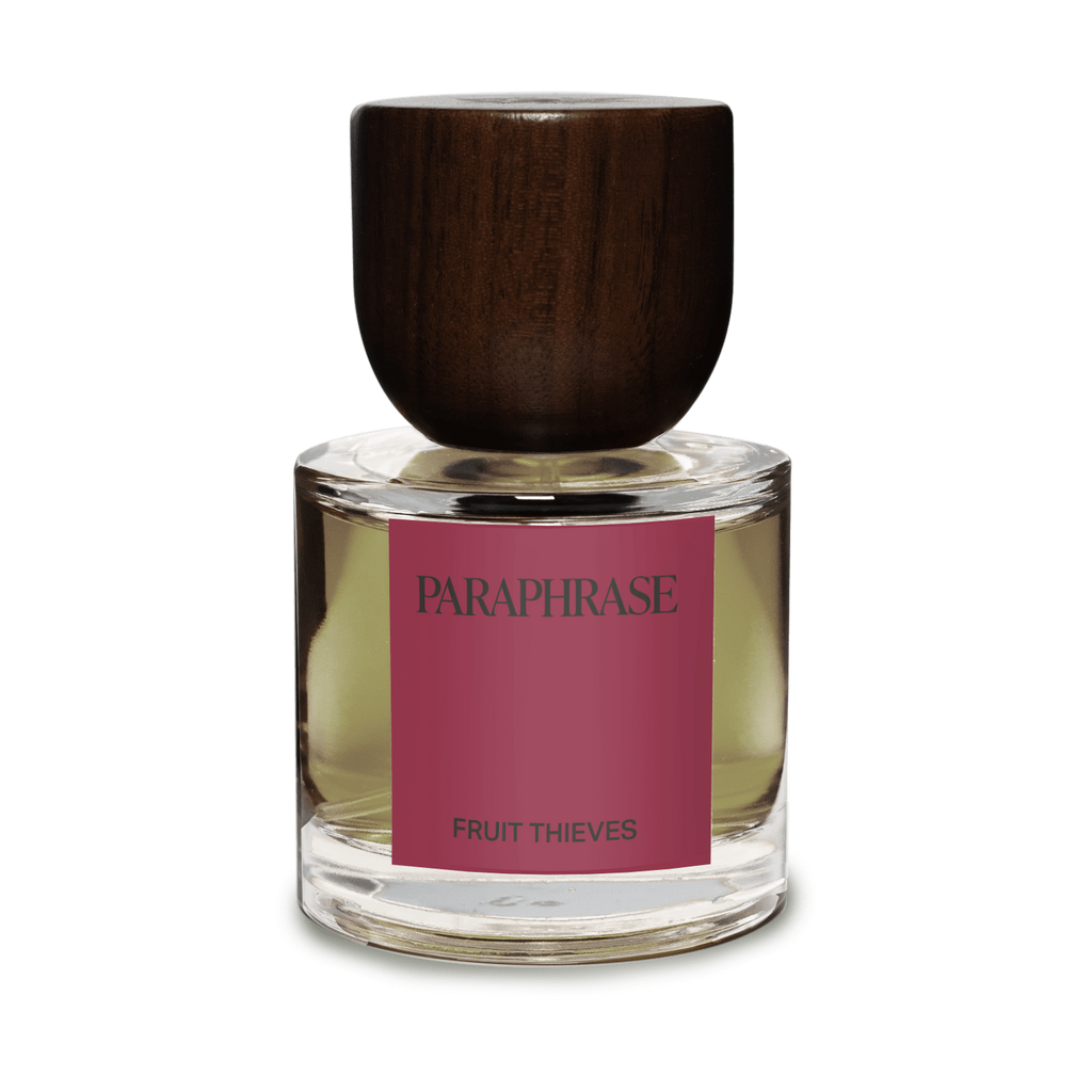 Paraphrase Fruit Thieves perfume bottle with wooden cap and pale amber liquid on white